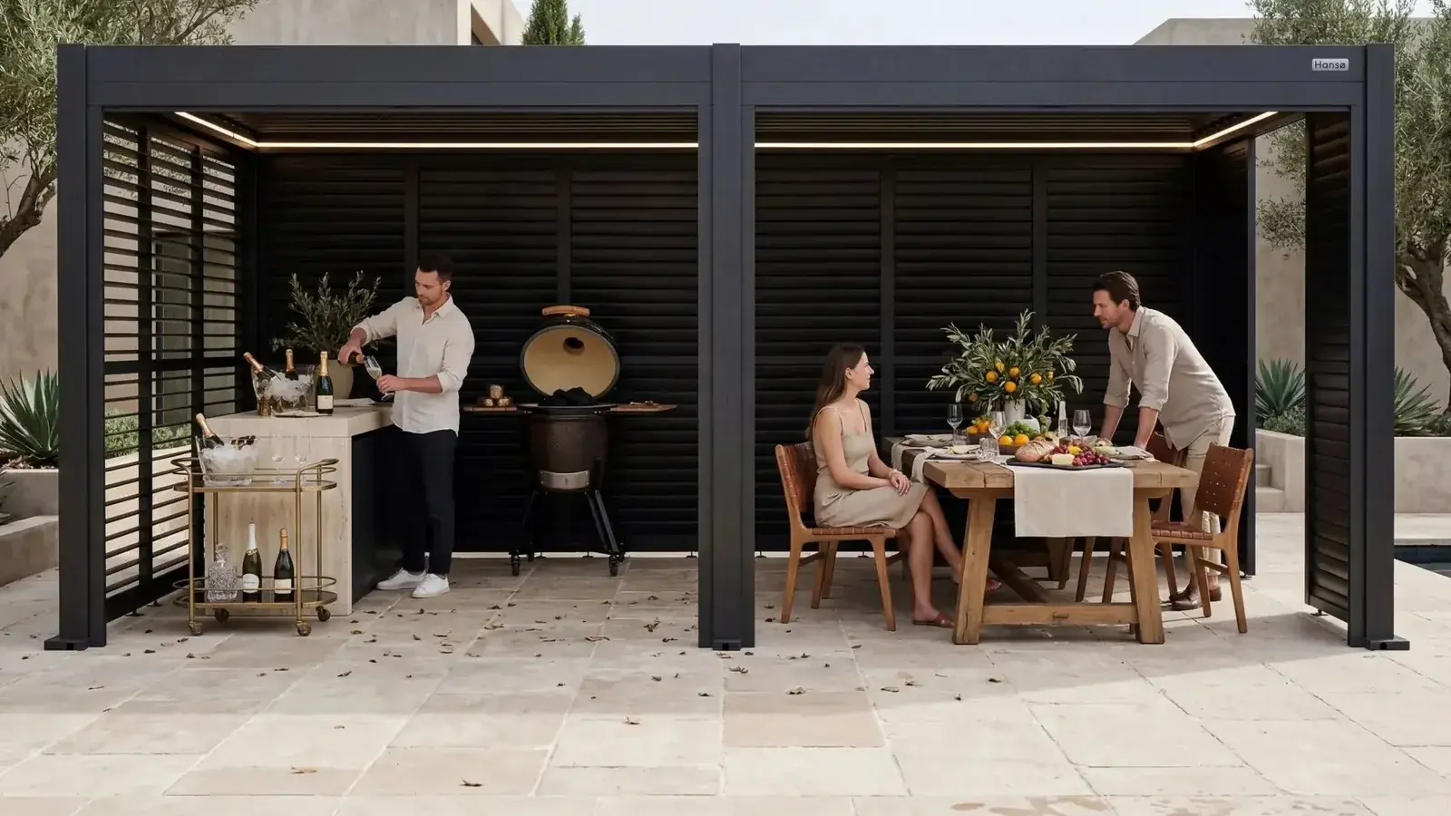 Two-section dark gray Hansø Horizon louvered pergola fitted with slatted side and back screens, with a dining table, a bar cart and a grill underneath