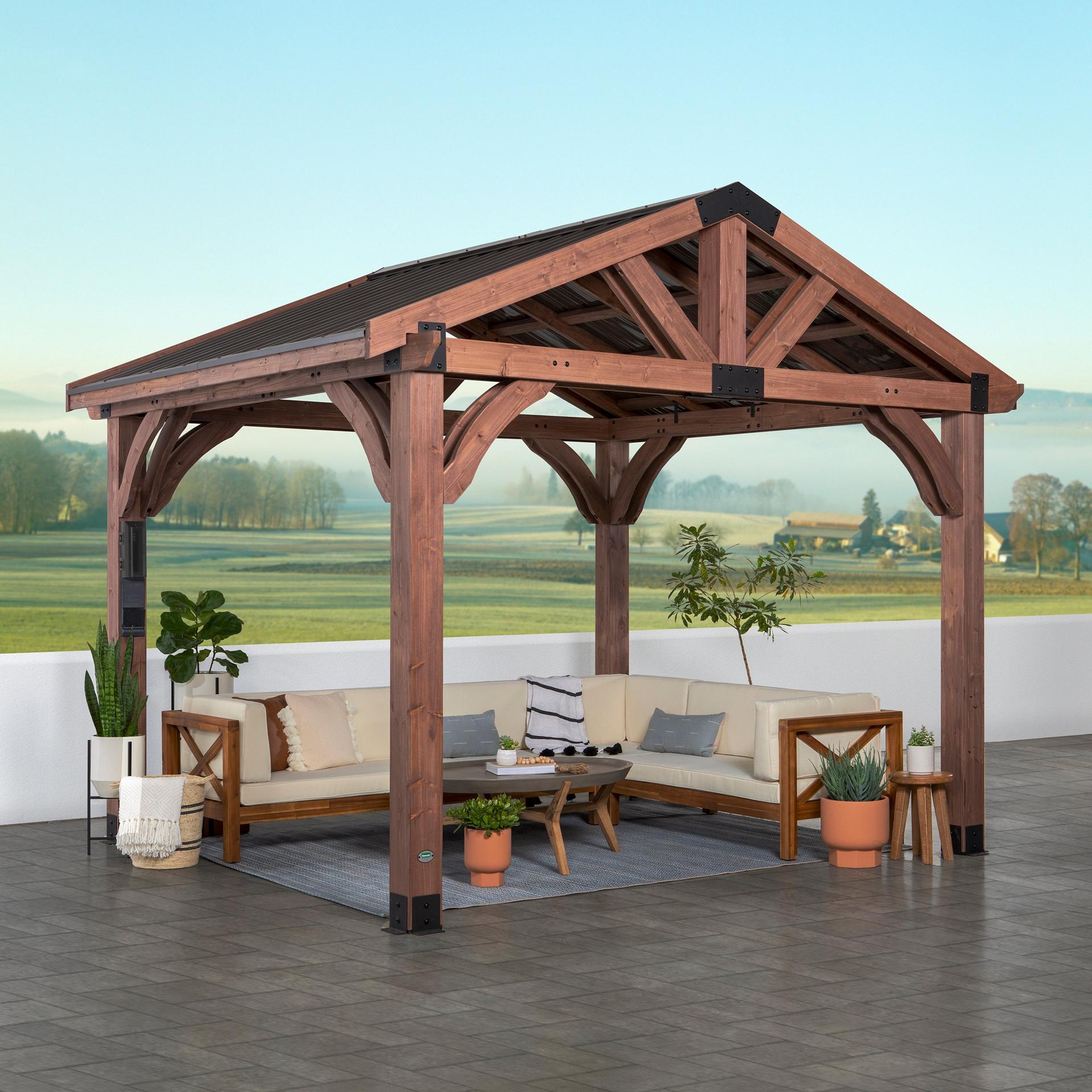 Backyard Discovery Arlington cedar gazebo with a peaked steel roof over a corner sofa and coffee table