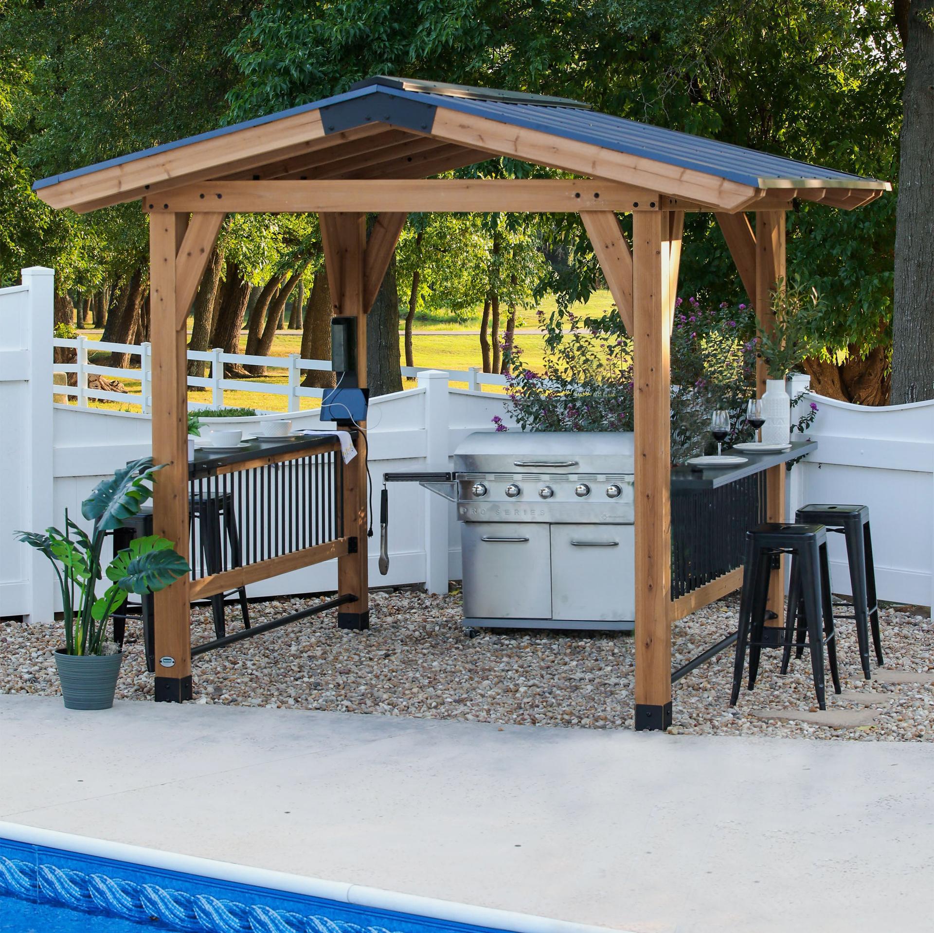 Backyard Discovery Granada cedar grill gazebo with a steel hip roof and bar tops beside a pool