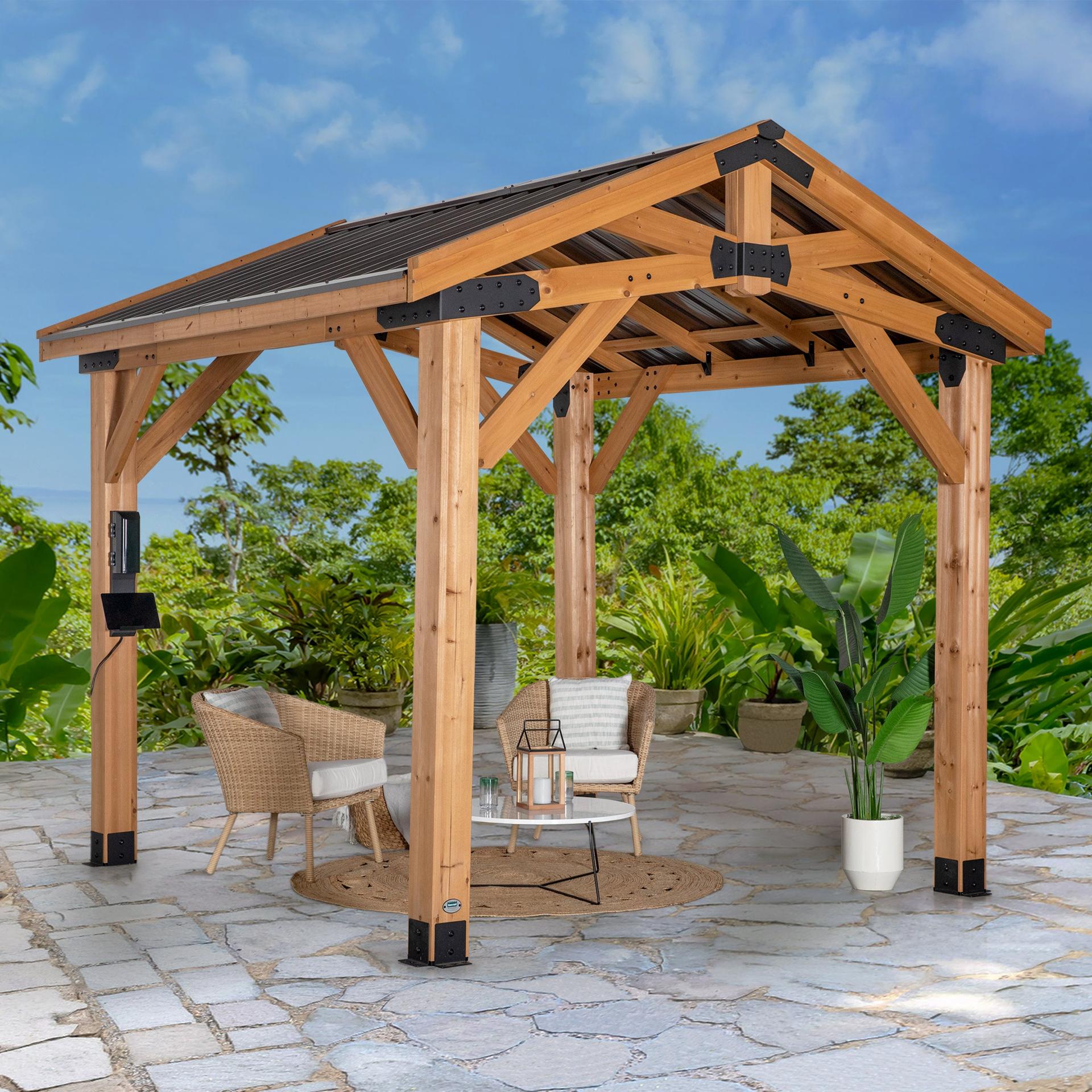Backyard Discovery Norwood cedar gazebo with a peaked steel roof over outdoor seating on a paver patio