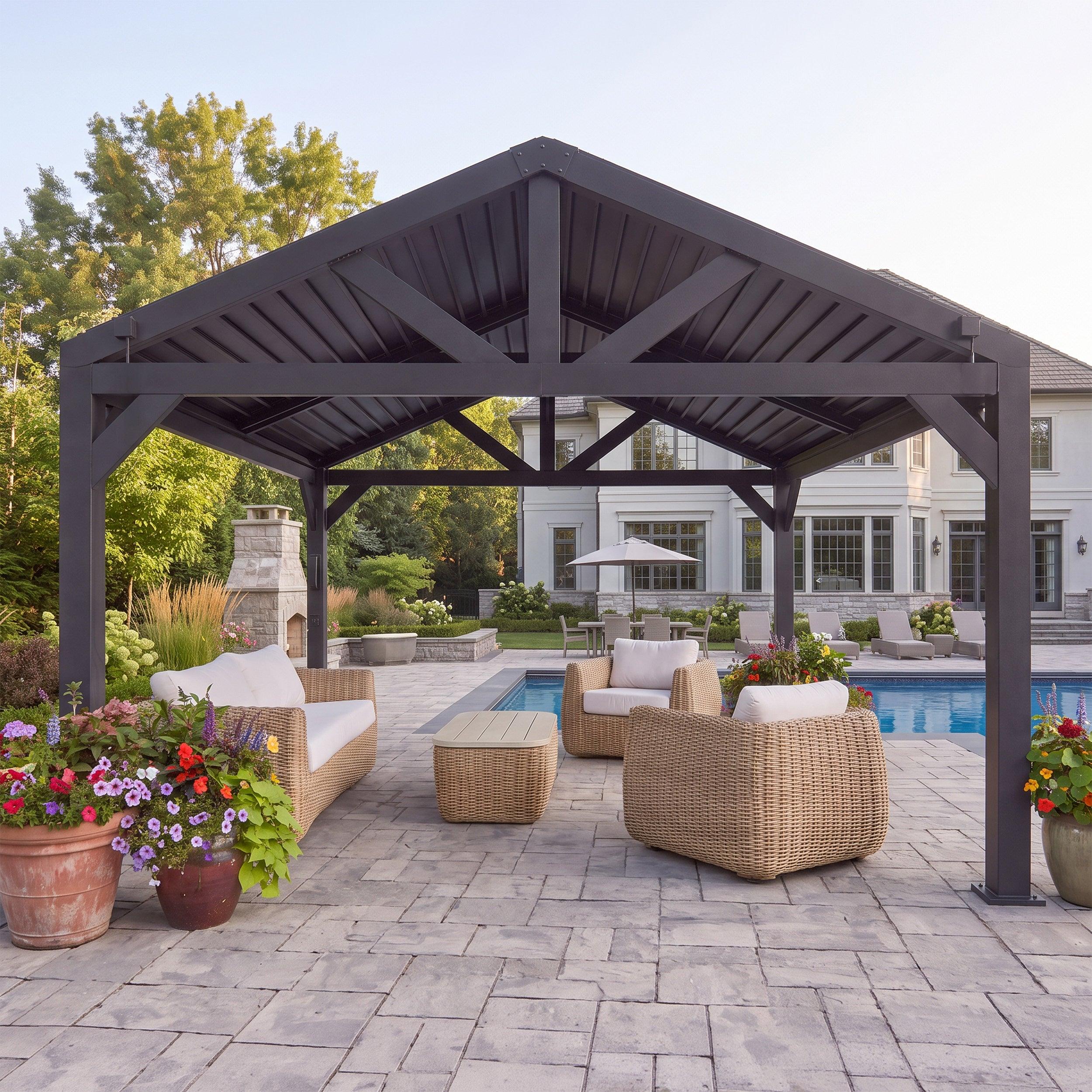 Black Ridgeline louvered pergola seen from the front on a stone patio, showing the peaked gable and steel trusses