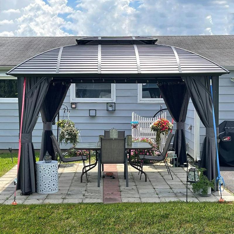 Domi Outdoor Living arc-roof hardtop gazebo with gray curtains over a dining table on a paver patio