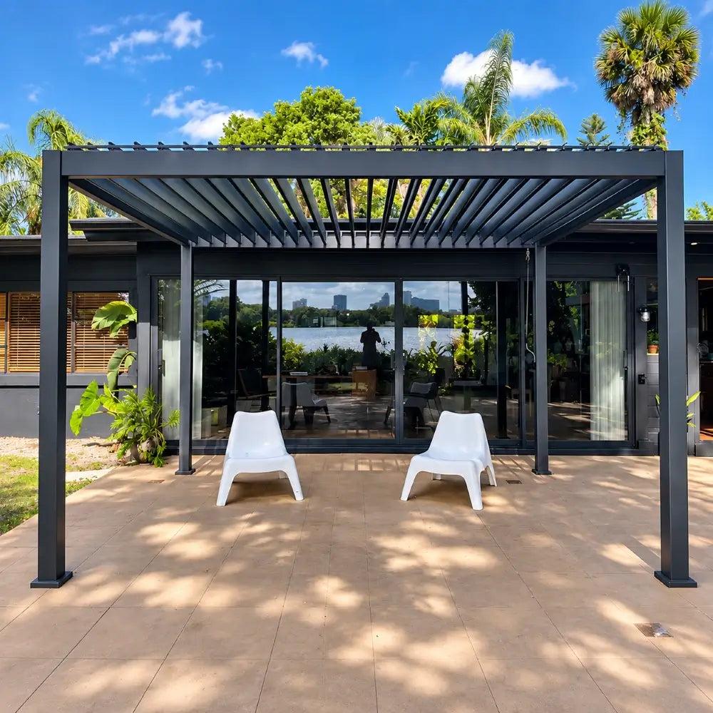 Domi Outdoor Living metal louvered pergola with open louvers over two white chairs on a tiled patio