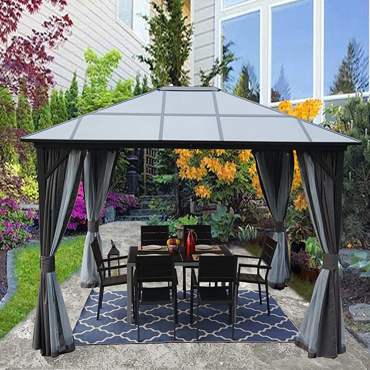 Kozyard Edward polycarbonate-roof gazebo with gray curtains over a dining table on a patterned rug