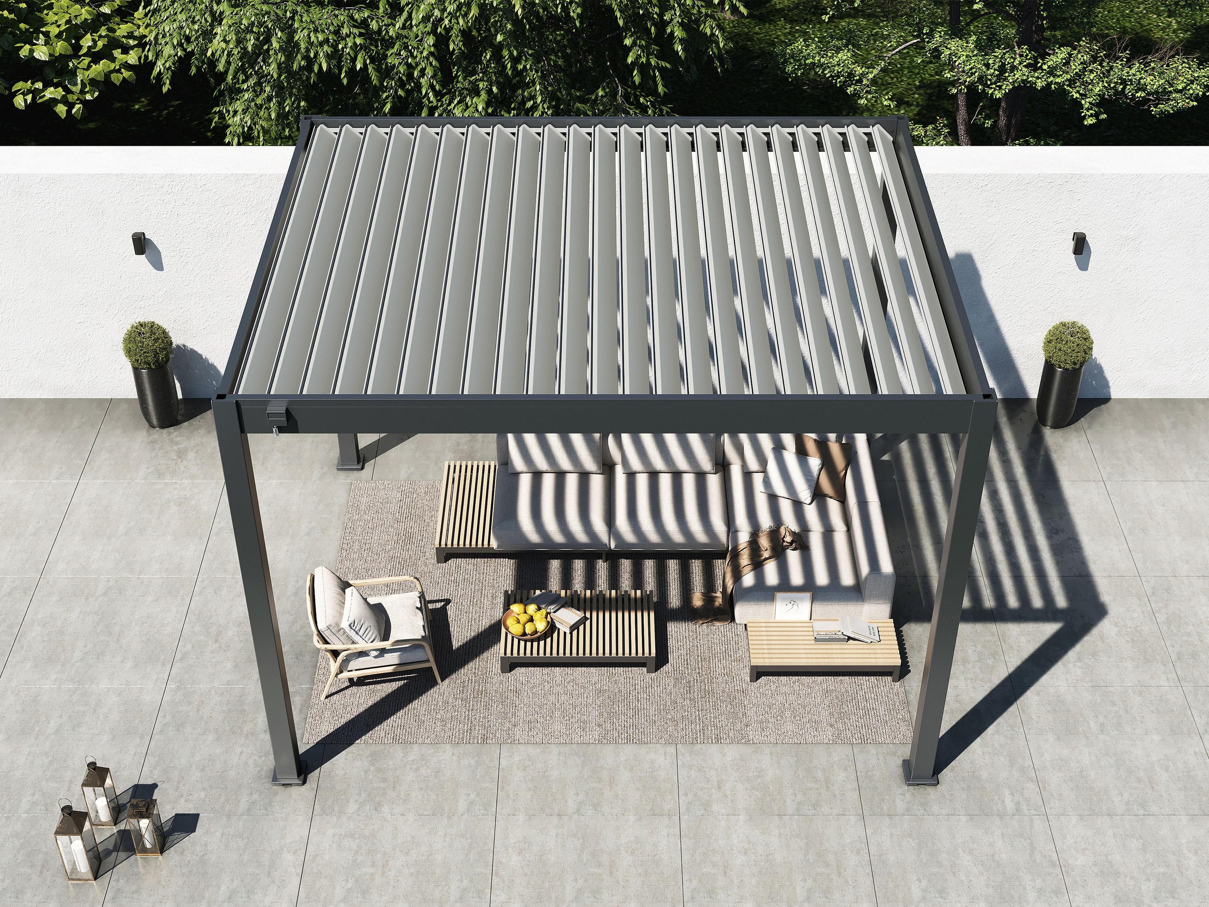 Overhead view of the 10' x 12' Lugano louvered pergola shading a sofa set on a walled terrace, louvers open