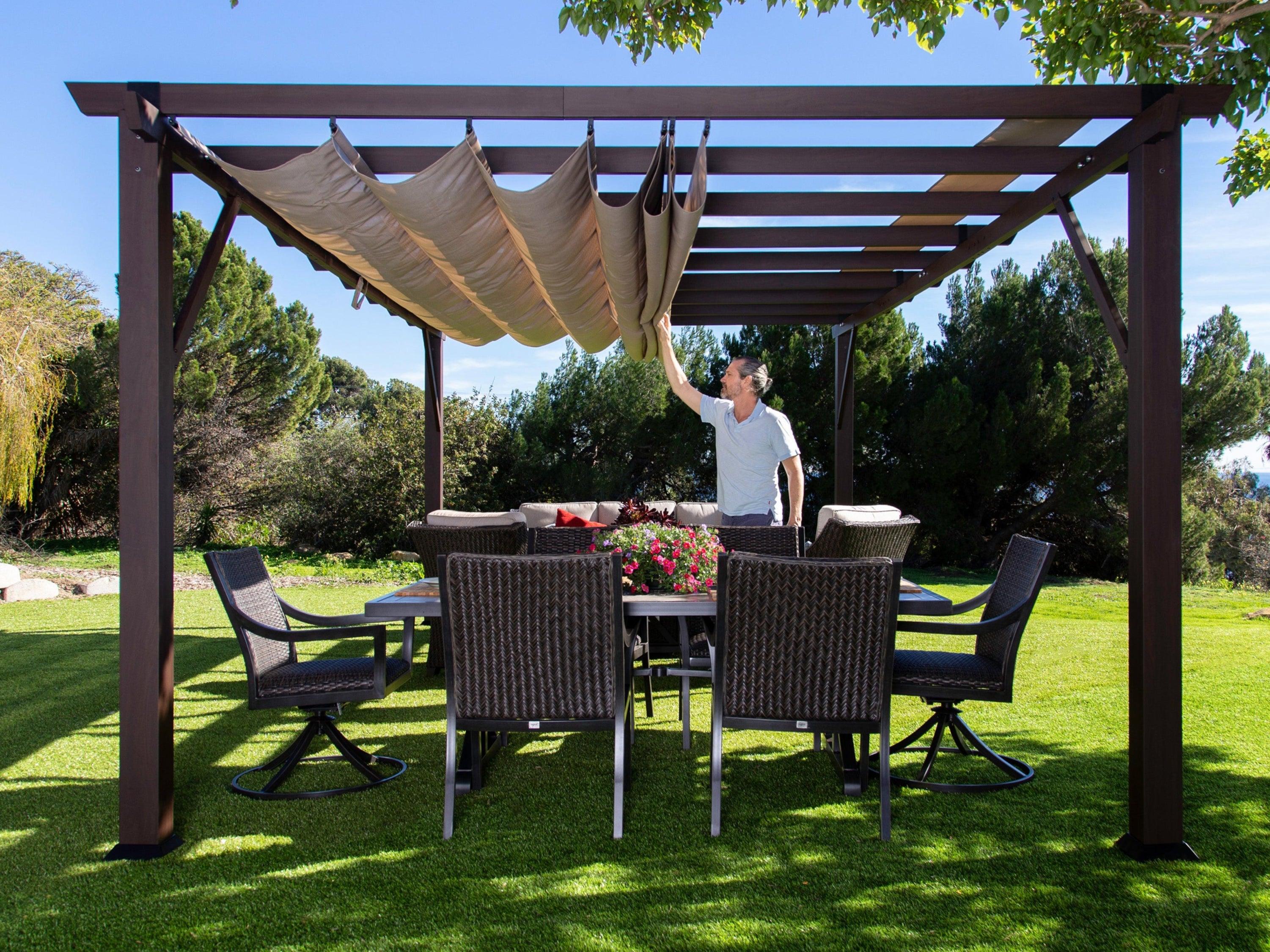 Paragon Outdoor Modena soft top pergola in Espresso wood grain with the mocha canopy being drawn back over a garden dining set