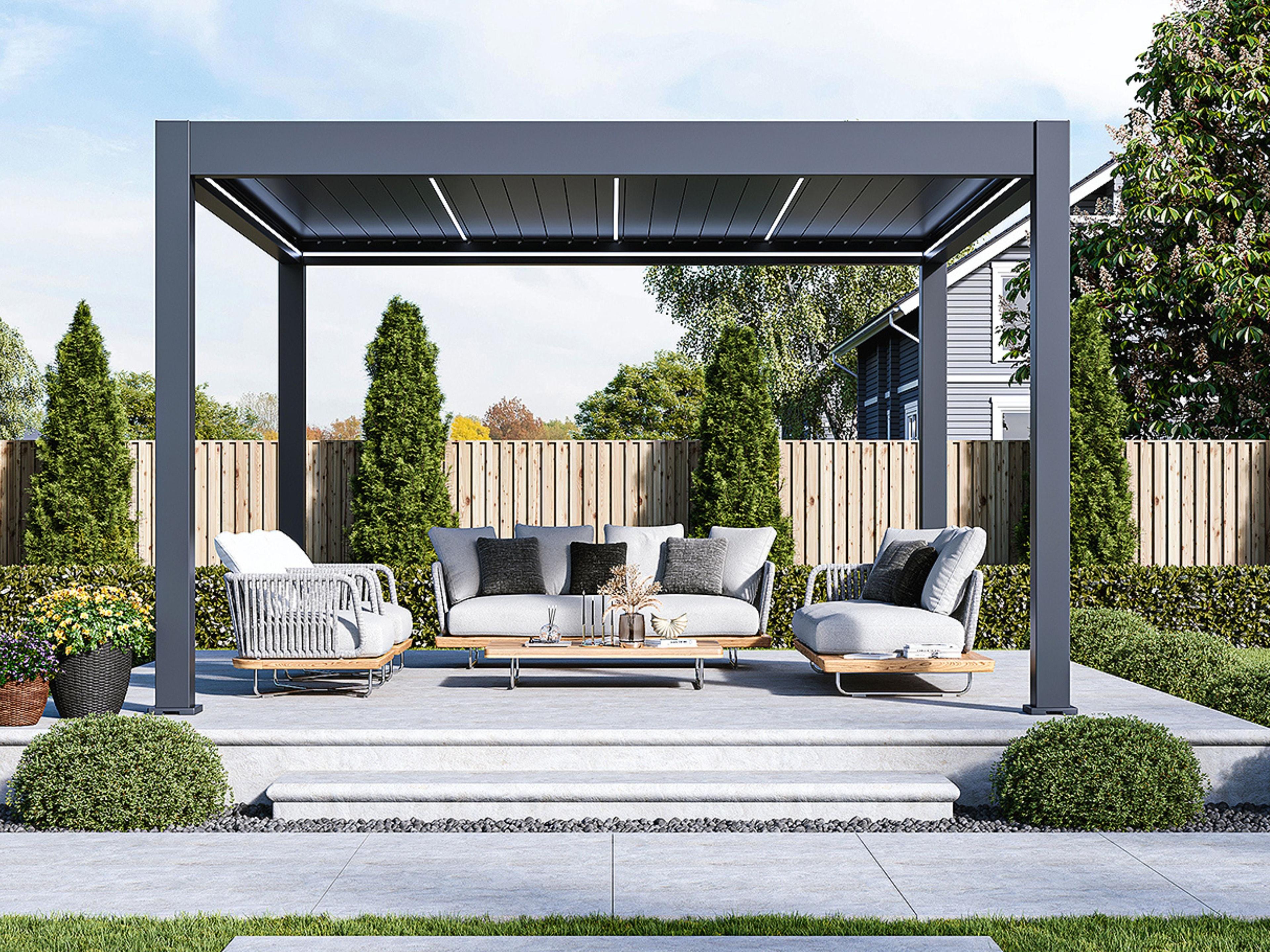 Paragon Outdoor Signature custom louvered pergola in a dark grey finish over a patio lounge set, louver LED lighting lit