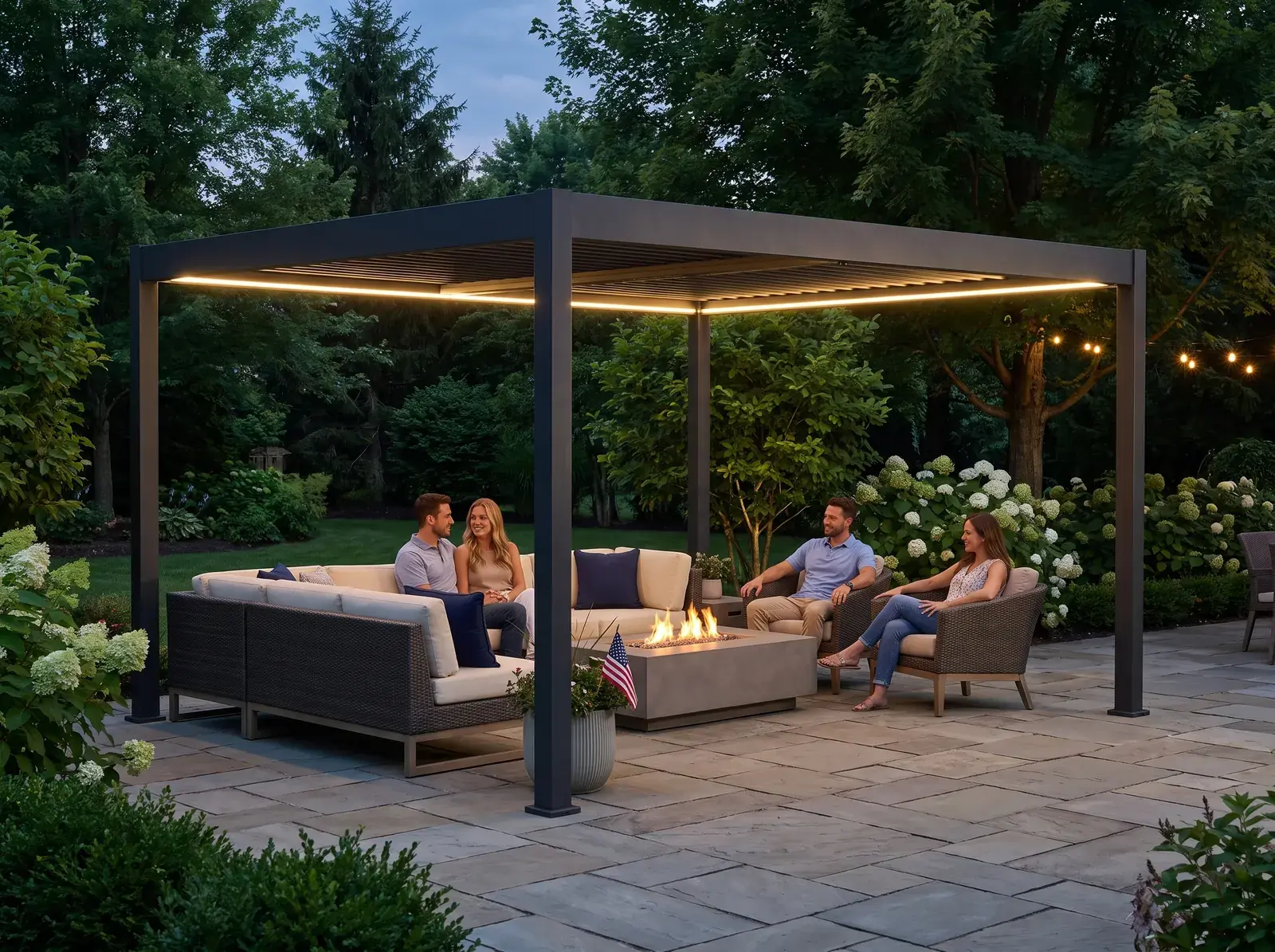 Paragon Suprema louvered pergola with built-in lighting over a patio sofa set and fire table at dusk