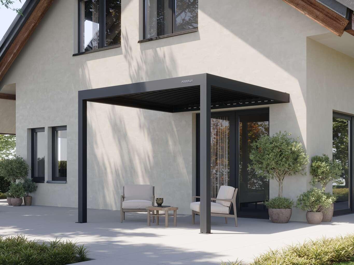 PERGOLUX Pergola 4 manual louvered pergola in anthracite, wall-mounted against a rendered house over a patio seating area