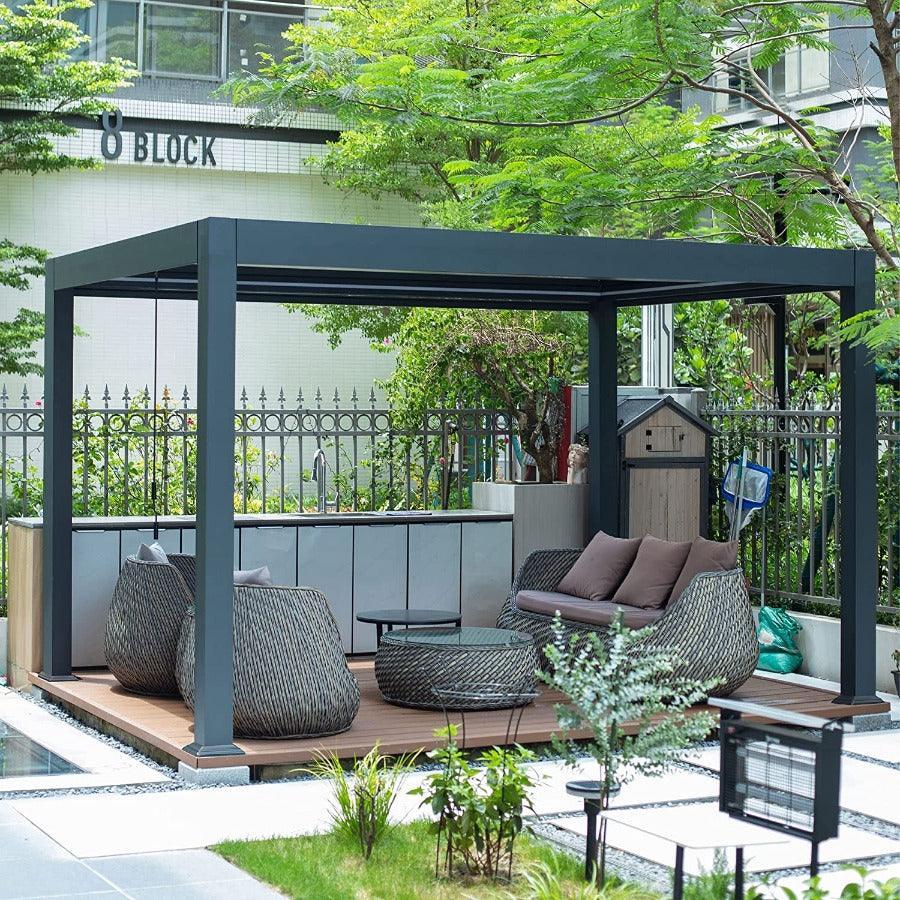 Grey PURPLE LEAF Caesar louvered pergola shading a decked courtyard seating area with wicker chairs