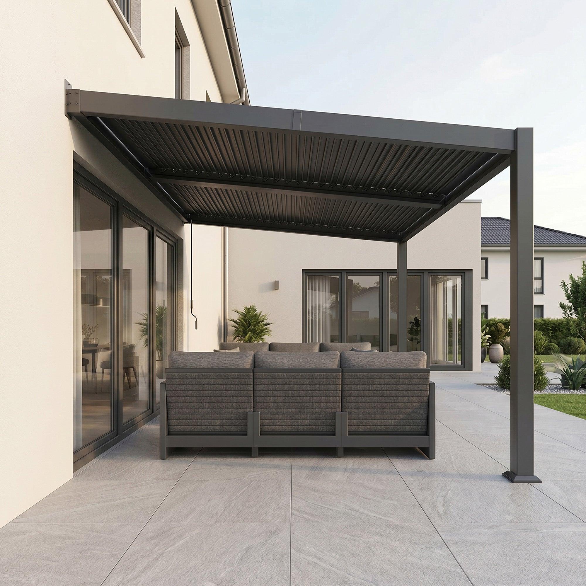 PURPLE LEAF Caesar wall-mounted louvered pergola in dark grey, fixed to a rendered house wall above a patio sofa