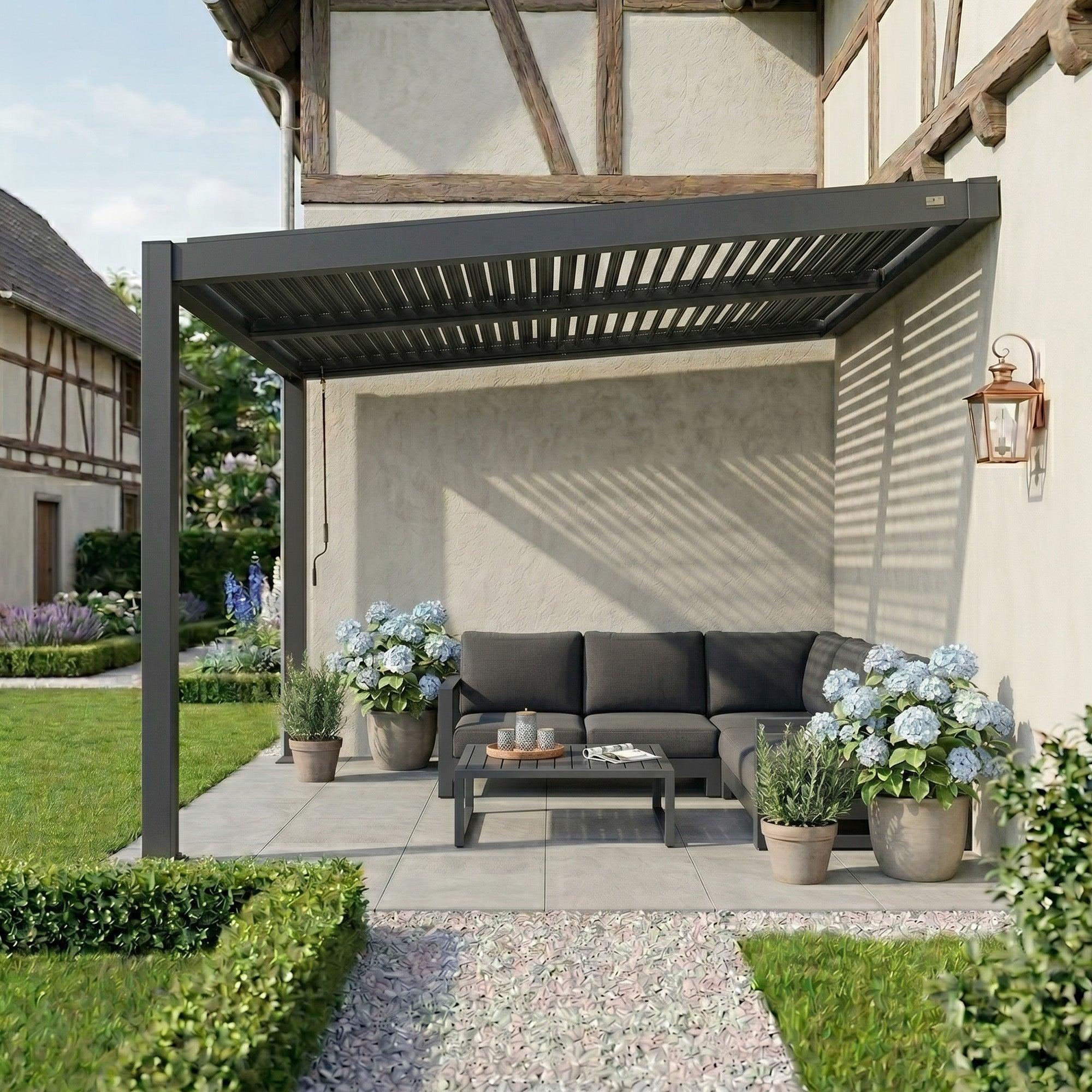 Dark grey PURPLE LEAF Caesar wall-mounted lean-to pergola against a timber-framed house with a shuttered privacy panel