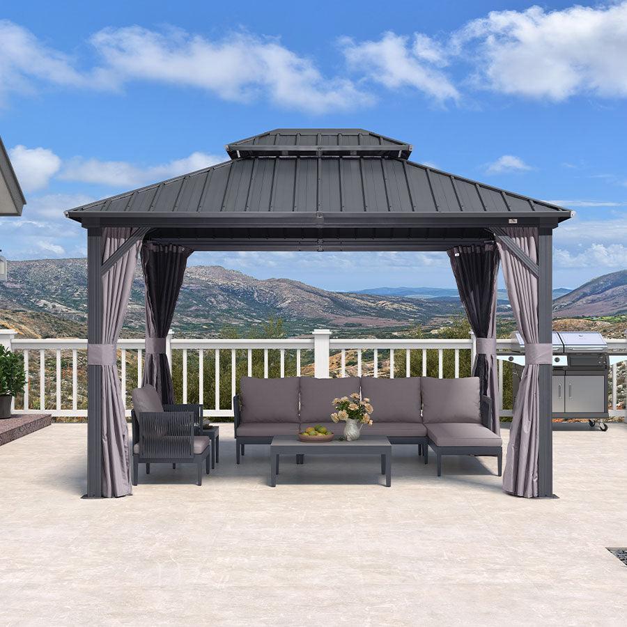Grey hardtop gazebo from the front with a sectional sofa and coffee table under the roof