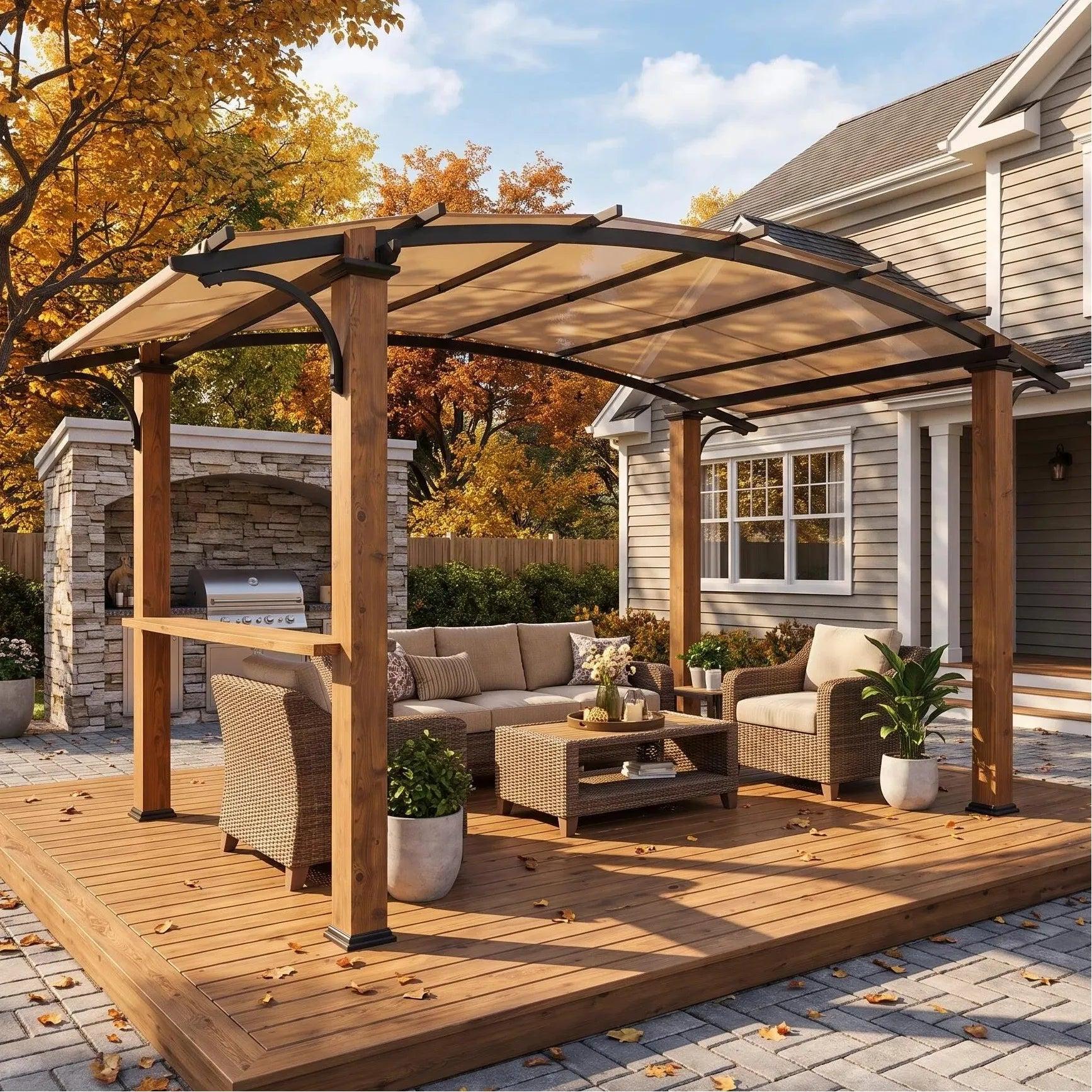 Sunjoy Arcadia Arched Canopy pergola on a wooden deck over a wicker lounge set beside a stone outdoor kitchen