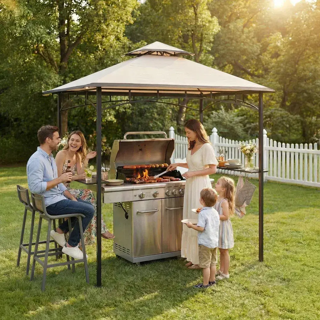 Sunjoy BBQ 2-Tier Grill Canopy 5x8 on a lawn, a family gathered around a gas grill sheltered beneath the beige canopy
