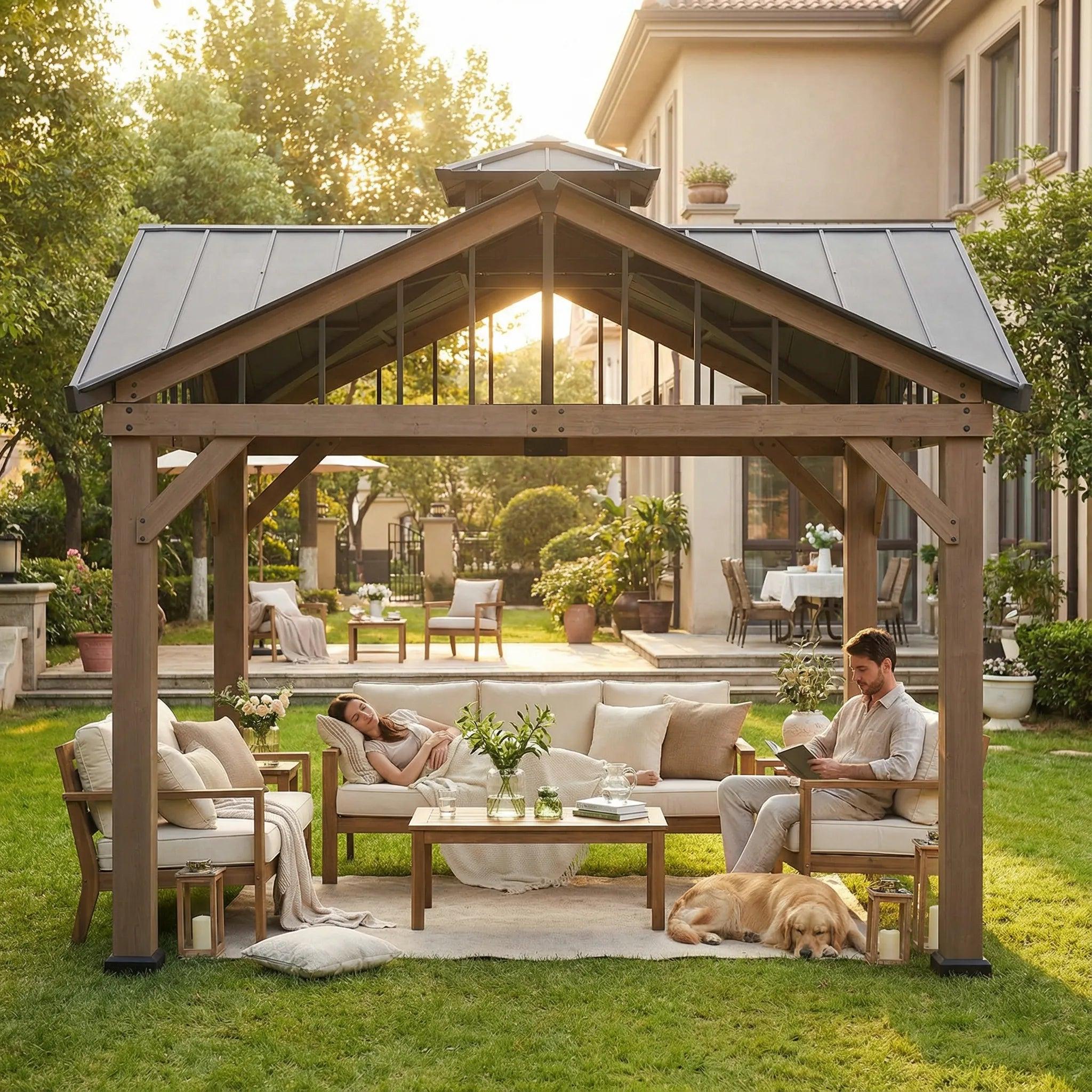 Sunjoy 12x12 heavy-duty wooden gazebo on a lawn at dusk, sheltering a sofa and armchairs with a dog lying on the rug