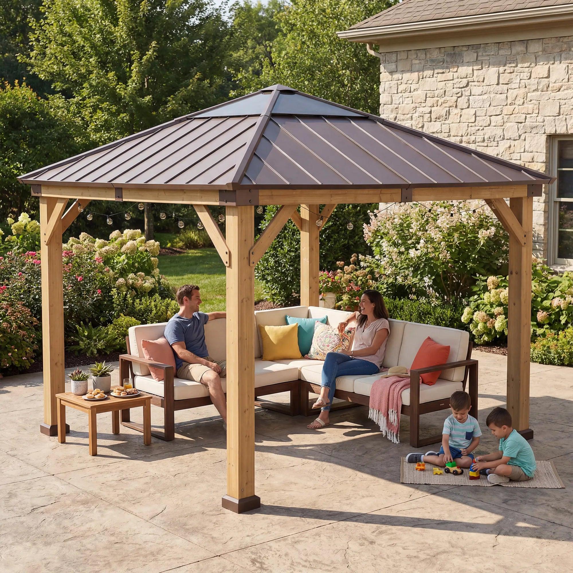 Sunjoy 11x11 wooden skylight gazebo on a patio with a family seated on a corner sofa and a child playing on the paving