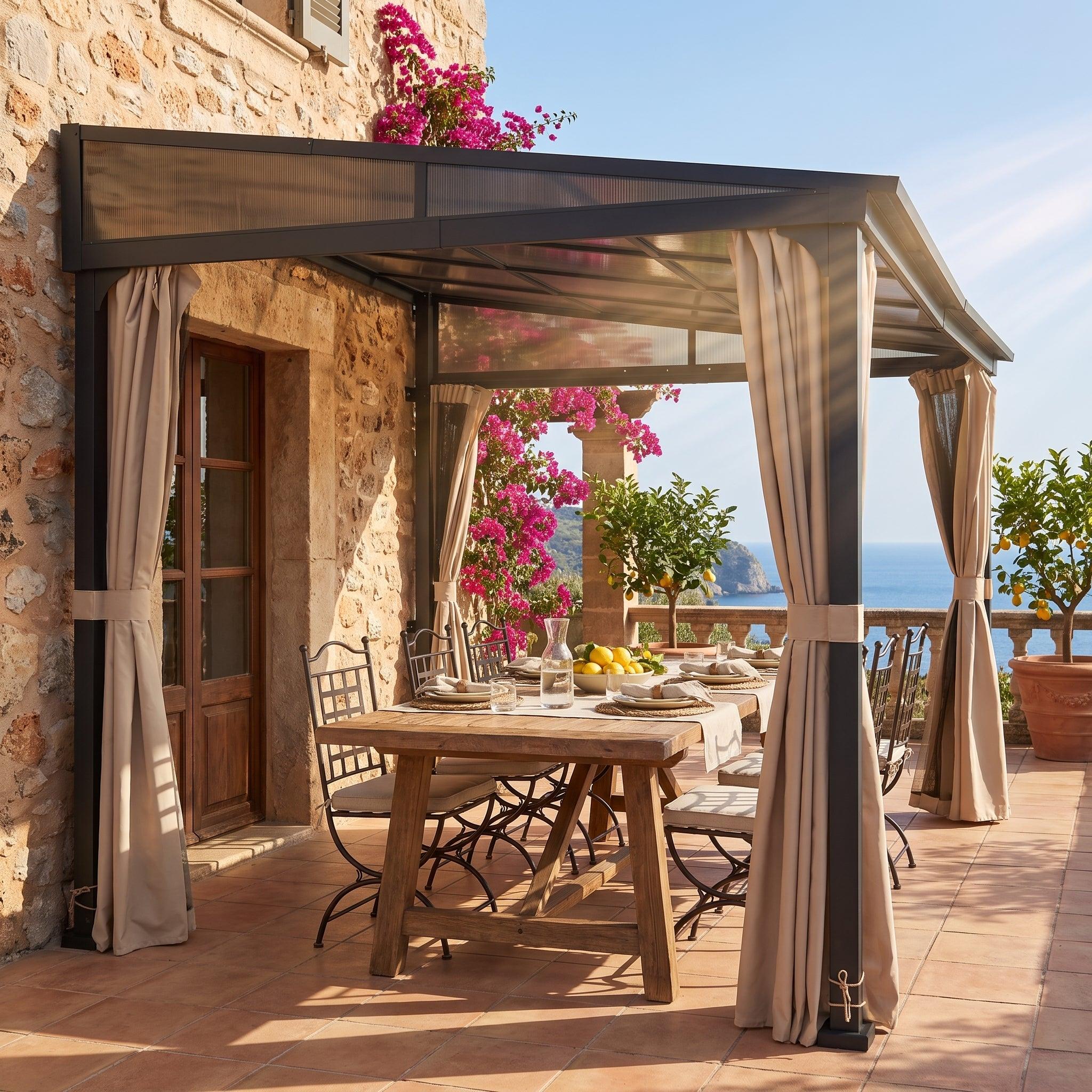 Sunjoy Vista PC-roof wall-mounted gazebo 10x12 fixed to a stone house wall above a laid dining table on a terrace