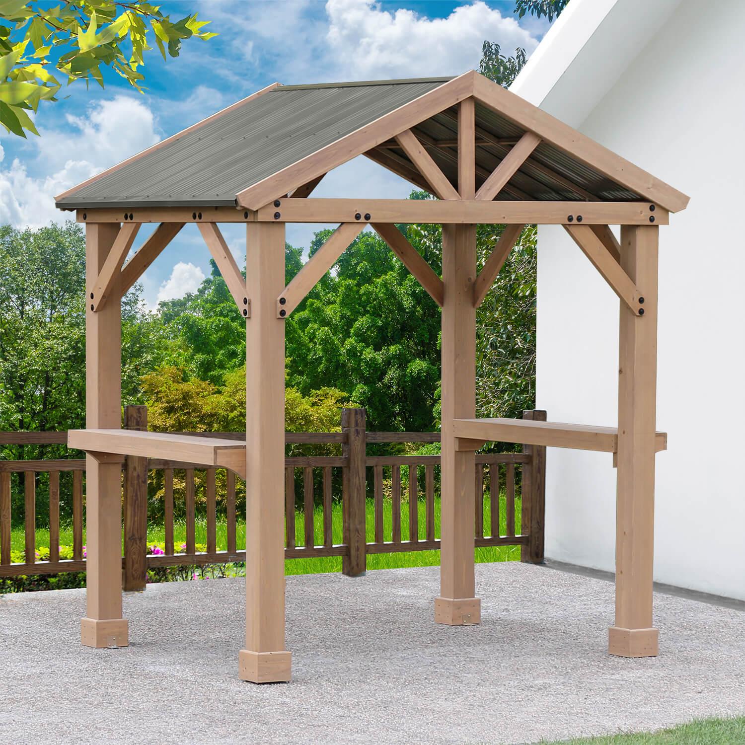 Yardistry Backyard Grilling Pavilion with counter shelves and a metal roof beside a white house