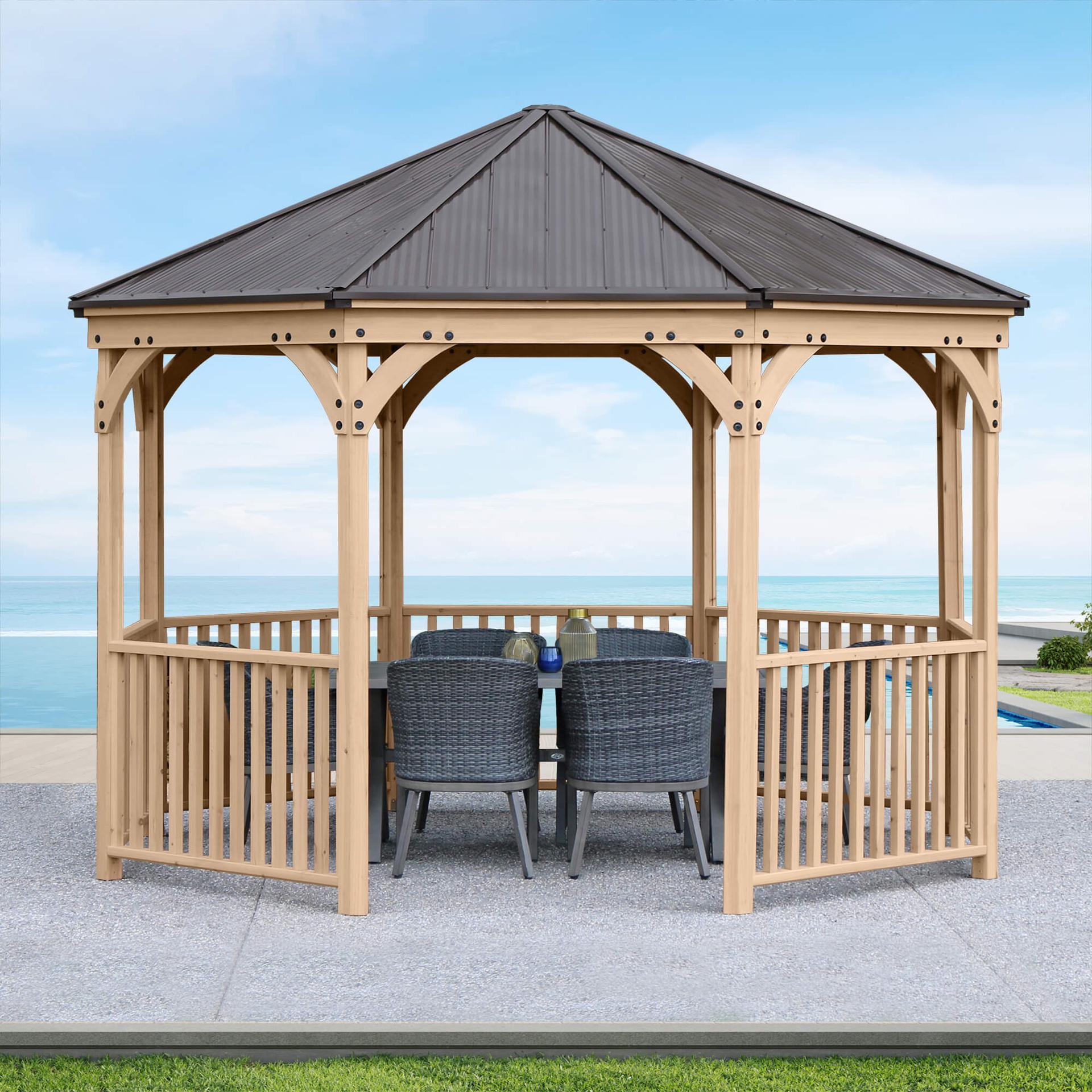 Yardistry 12 ft Meridian octagon gazebo in cedar with a spindle railing and aluminum roof beside a pool
