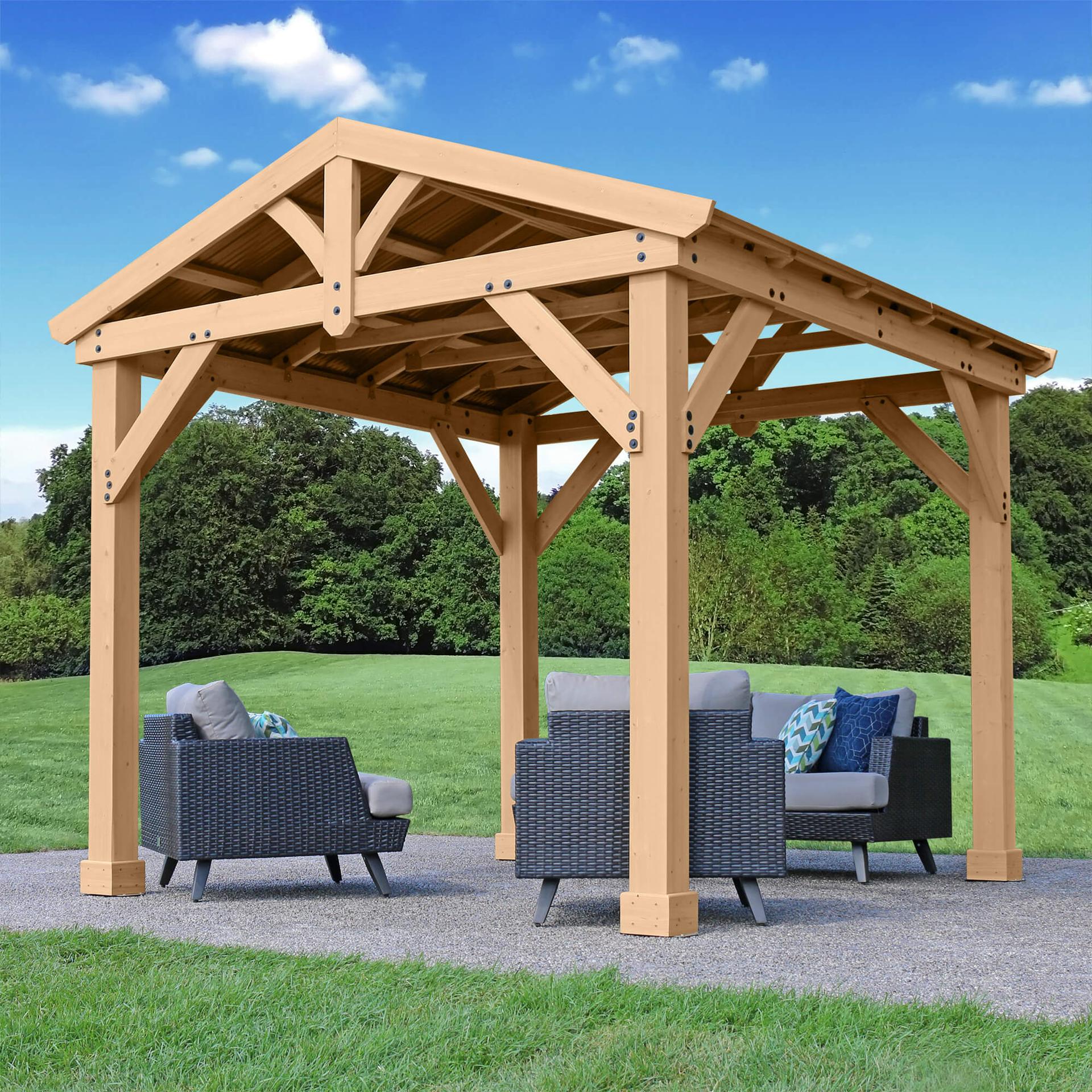 Meridian pavilion on a lawn with armchairs and a coffee table under the gable roof