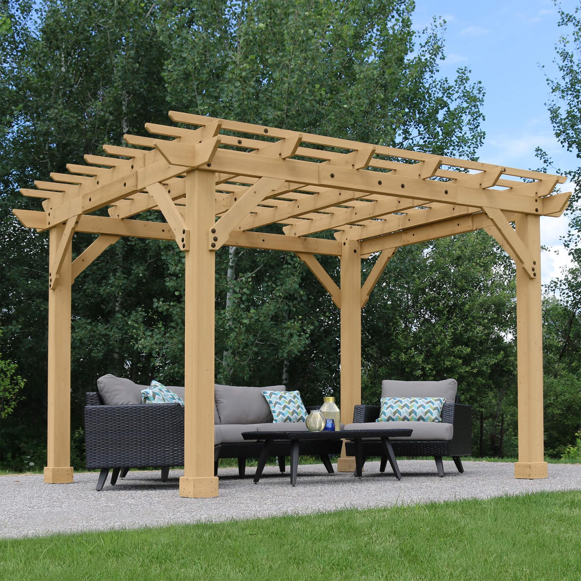 Yardistry Meridian Pergola in cedar with a crisscross trellis roof over an outdoor sofa set on gravel