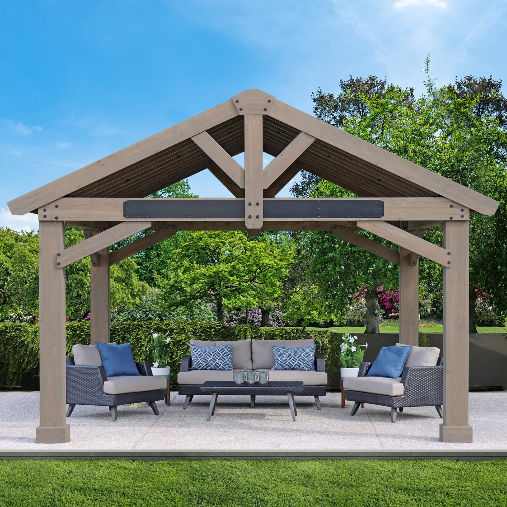 Timber Frame Pavilion on a lawn patio with a long sofa and armchairs