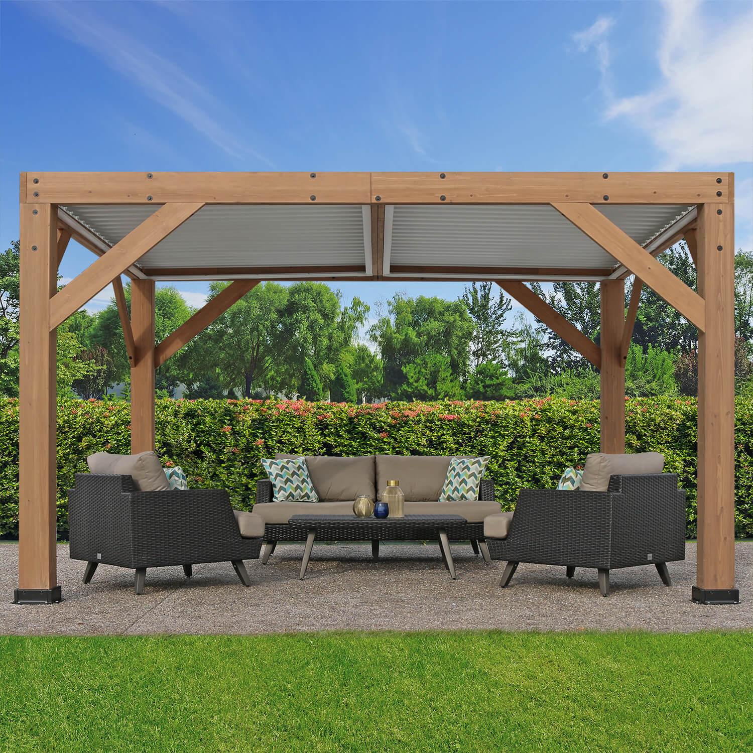 Yardistry 13 x 11 Wood Room With Louvered Roof, cedar posts and beams under a white aluminium louvered roof, over a rattan lounge set on a garden hardstanding